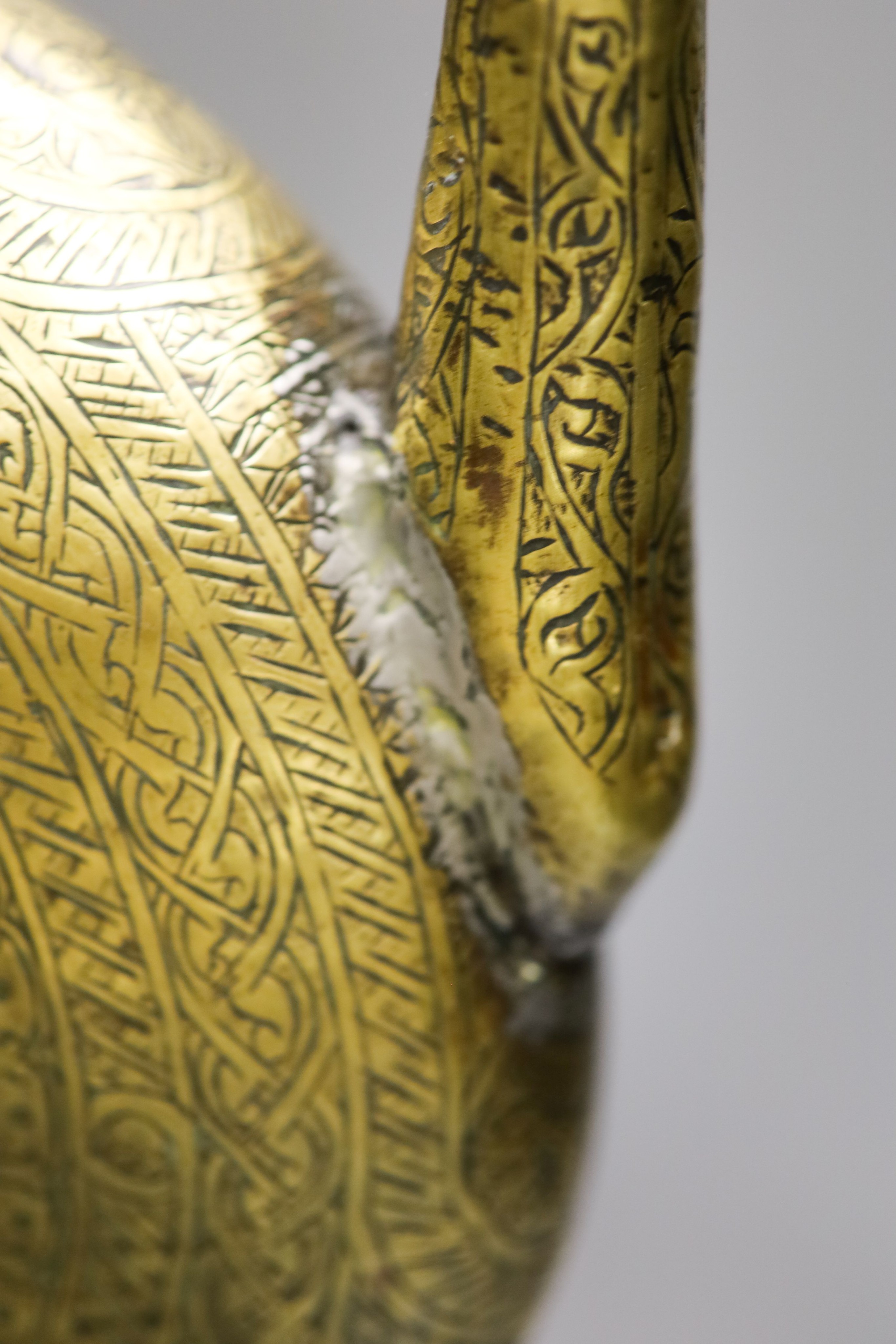 A Persian engraved brass ewer and Middle-eastern horn and white metal priming shot flask 57cm